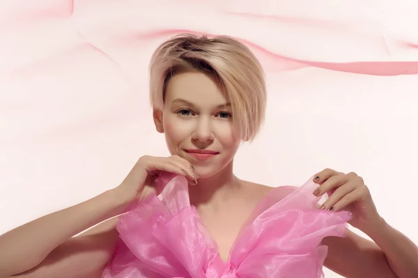 Blonde woman in pink bow — Stock Photo, Image