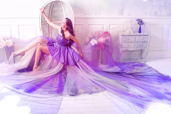 Woman posing in long purple dress Stock Photo