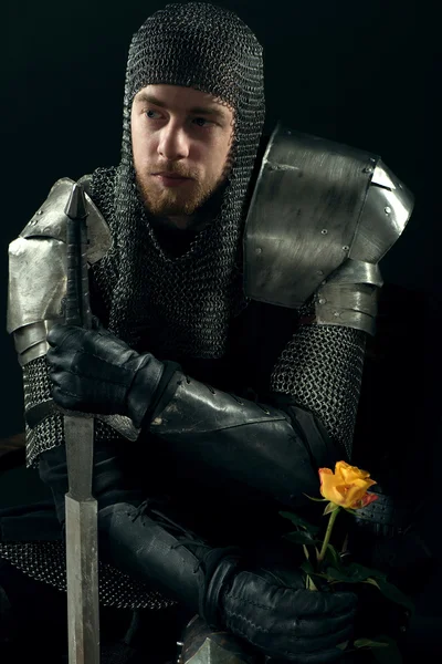 Ancient knight with yellow rose — Stock Photo, Image