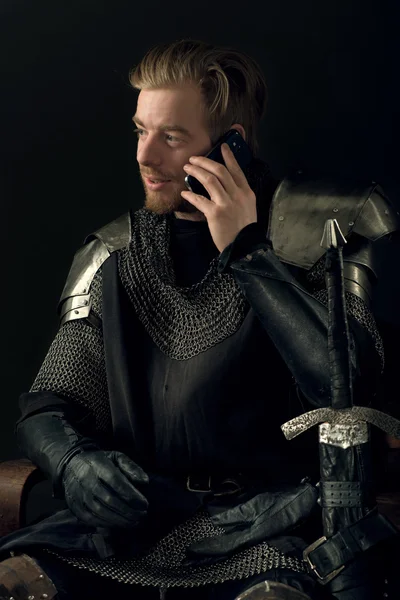 Ancient knight talking on mobile phone — Stock Photo, Image