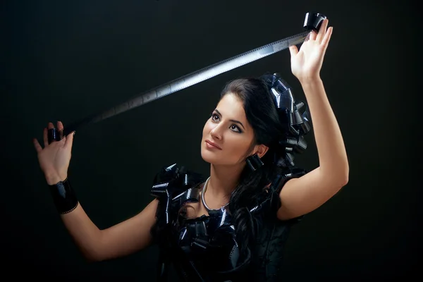 Brunette woman with camera rolls — Stock Photo, Image