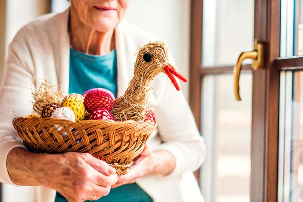 Woman holding basket with Easter eggs — Stock Photo, Image