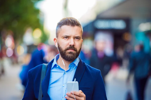 Manager with smartphone listening music — Stock Photo, Image