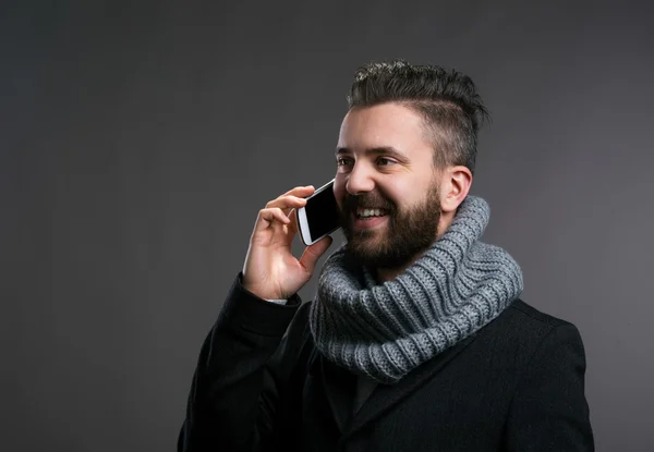 Hombre en ropa de invierno con teléfono inteligente, haciendo una llamada telefónica — Foto de Stock
