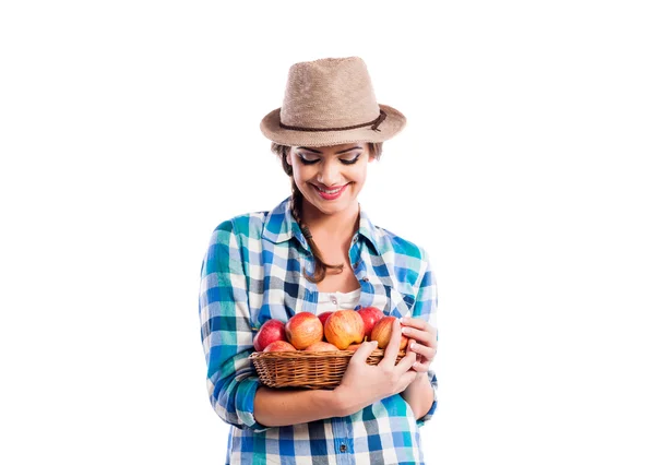 Woman, checked shirt holding basket with apples. Autumn harvest — Stock fotografie