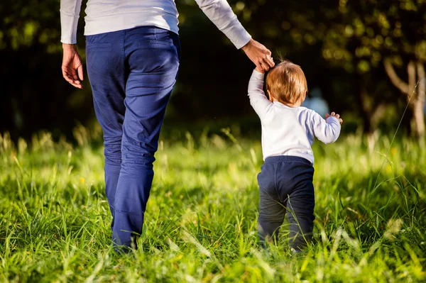 Mother holding hands of her son — Stock Photo, Image