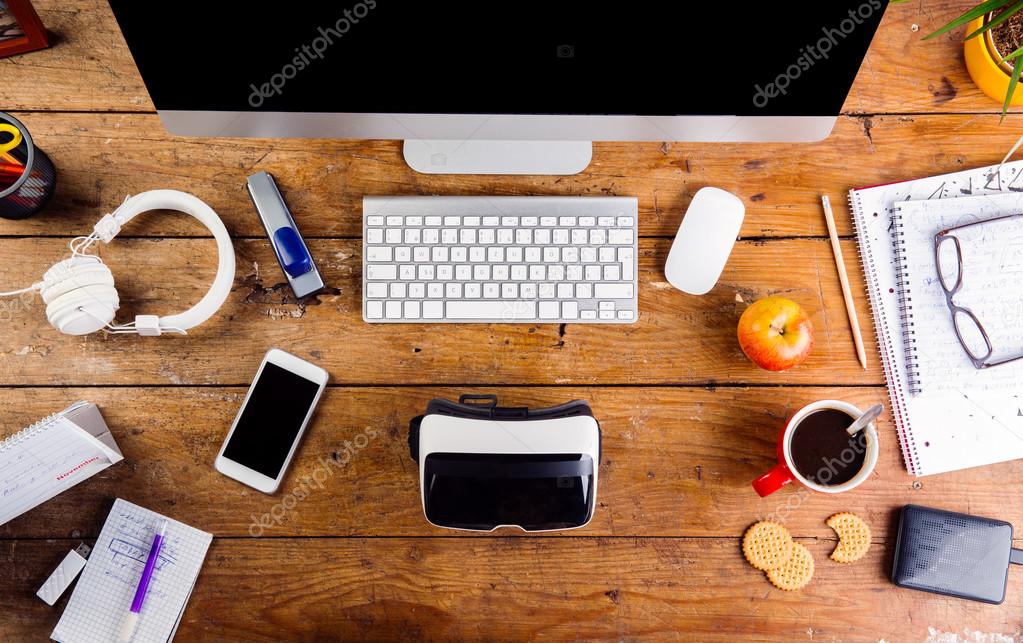 Desk with gadgets and office supplies. Stock Photo by ©halfpoint 103590282