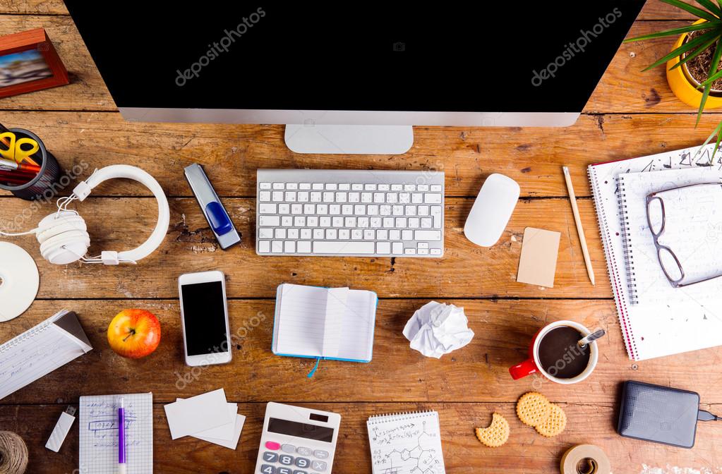 Desk with gadgets and office supplies.