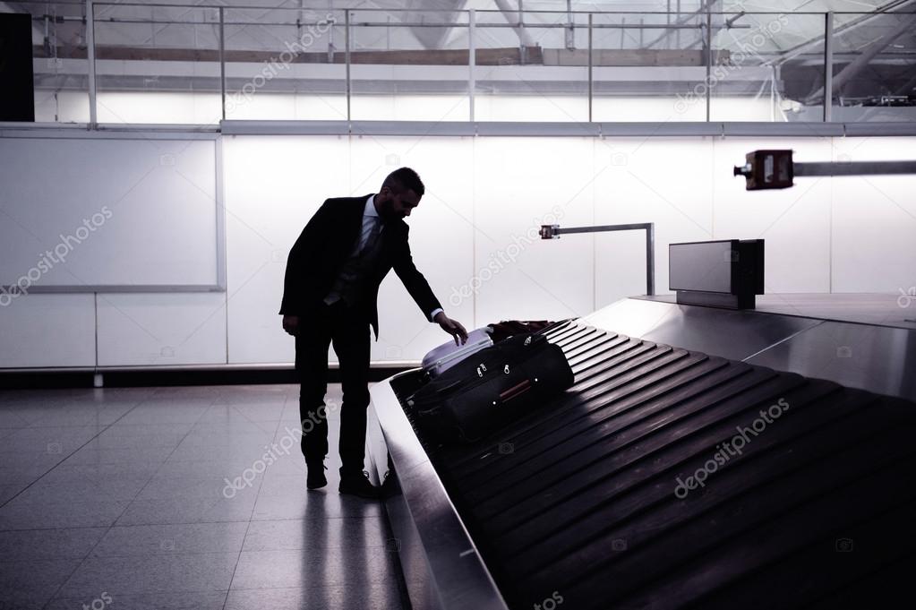 Businessman with luggage at airport