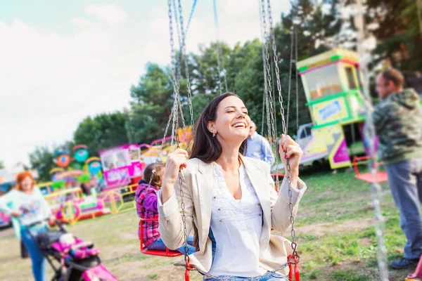 Mujer en la feria de la diversión, paseo swing —  Fotos de Stock