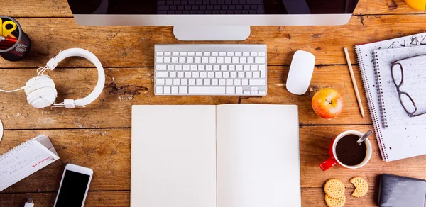 Desk, gadgets and office supplies. Flat lay. Wooden desk. Stock Photo by  halfpoint