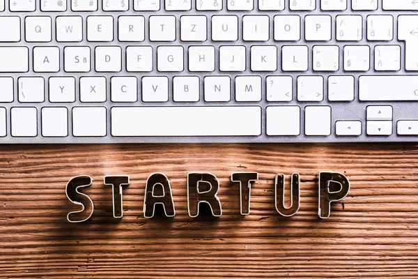 Start up sign and computer keyboard — Stock Photo, Image