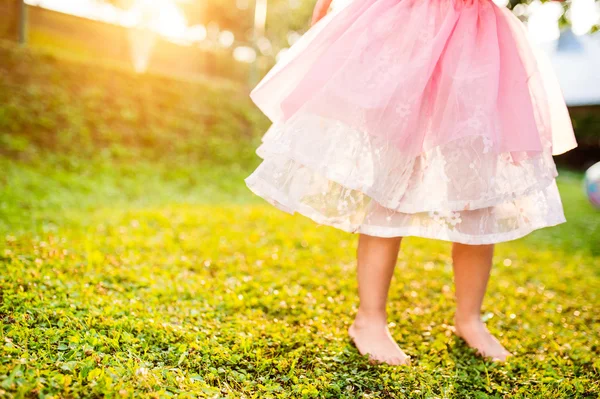 Girl in princess skirt in sunny garden — Stock Photo, Image