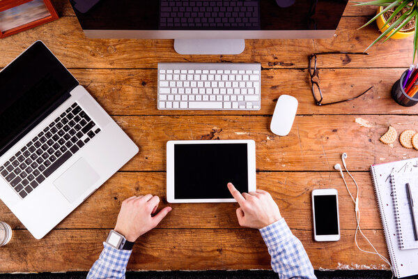 Business person working at office desk wearing smart watch
