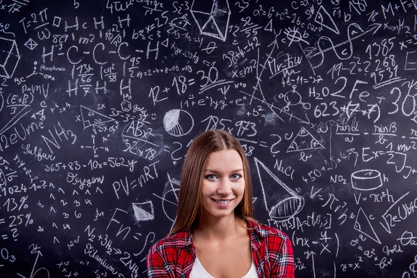 学生对大的黑板上用数学符号 — 图库照片