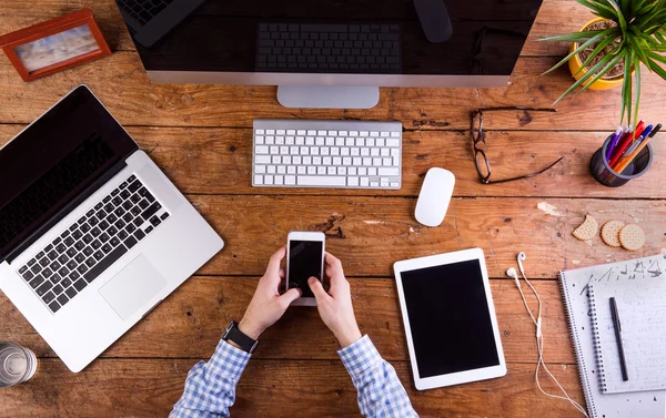 Business person working at office desk wearing smart watch — Stock Photo, Image