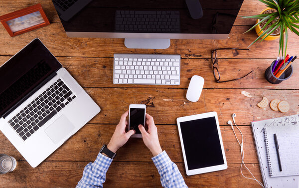 Business person working at office desk wearing smart watch