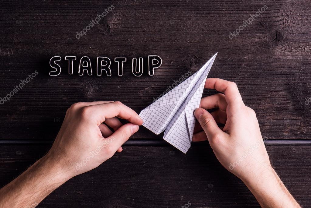 Office Desk With Start Up Sign And Paper Plane Stock