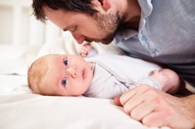 Babasıyla yatakta erkek bebek