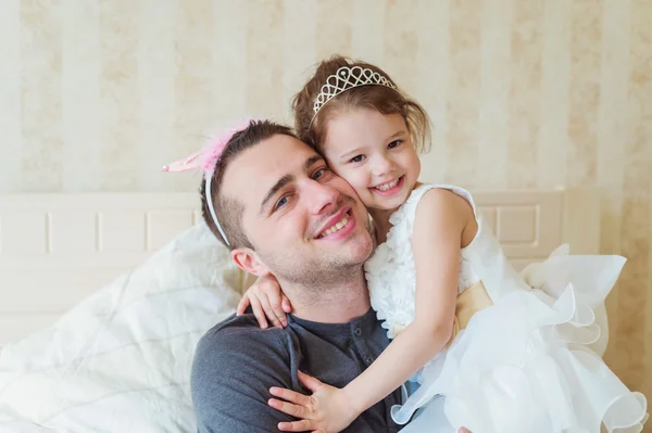 Menina bonito com seu pai vestindo coroas — Fotografia de Stock