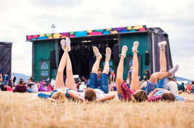 Legs of teenagers at music festival clipart