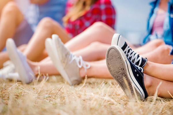 Legs of teenagers at summer music festival