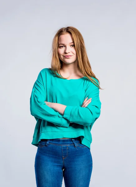 Girl in jeans and sweatshirt, young woman, studio shot — Stock Photo, Image
