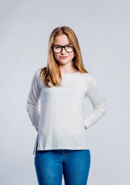 Girl in jeans and sweatshirt, young woman, studio shot — Stock Photo, Image