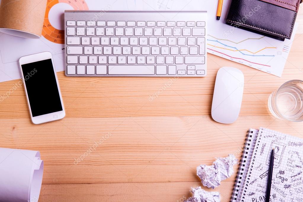 Gadgets and office supplies. Studio shot, wooden background. Stock Photo by  ©halfpoint 110784222