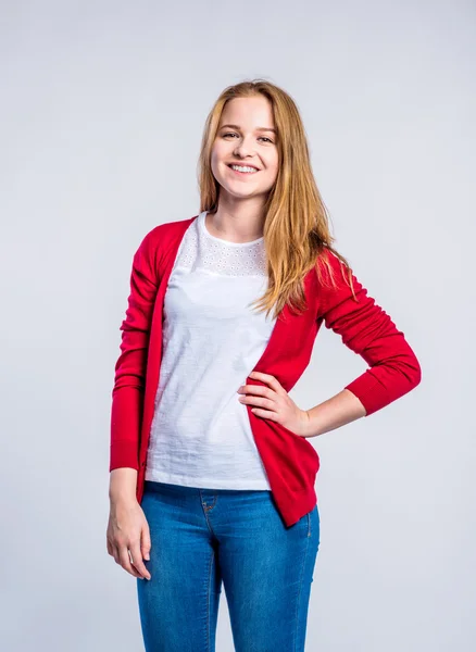 Girl in jeans and red cardigan, woman, studio shot — Stock Photo, Image