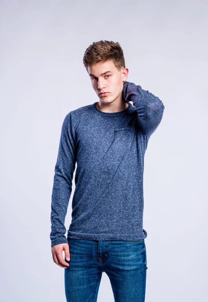 Boy in jeans and sweater, young man, studio shot — Stock Photo, Image