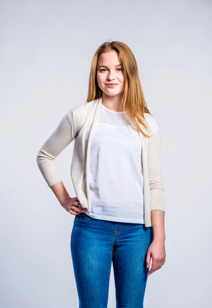 Girl in jeans and beige cardigan, woman, studio shot — Stock Photo, Image