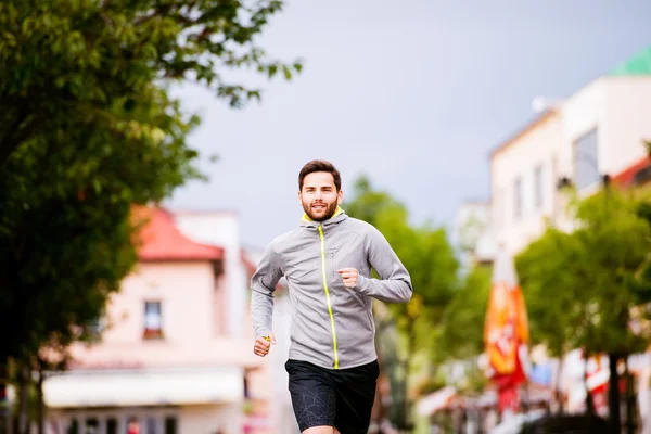 Young hipster man running in town — Stock Photo, Image