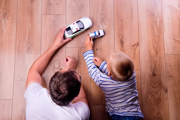 Pai com seu filho brincando com carros — Fotografia de Stock