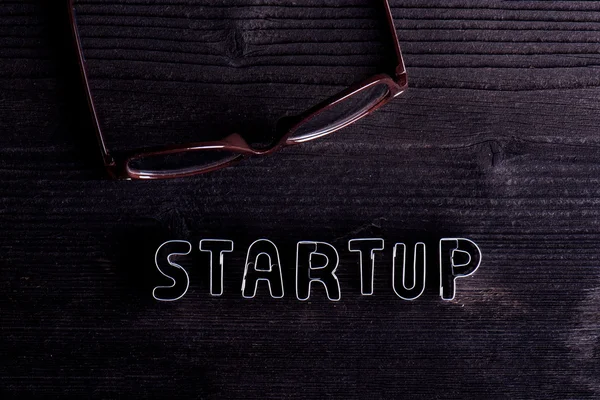 Start up sign made of cookie cutters. Wooden background. — Stock Photo, Image