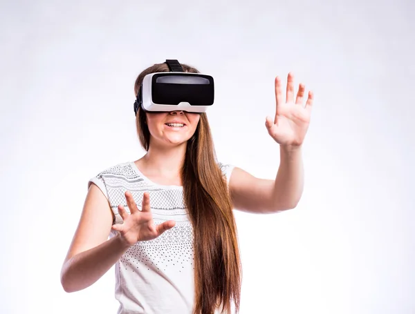 Mujer con gafas de realidad virtual. Estudio de tiro, fondo gris —  Fotos de Stock