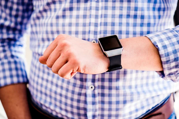 Close up of unrecognizable man using smart watch