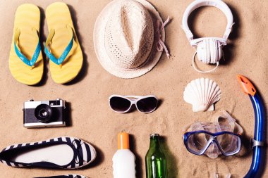Summer vacation composition. Sandals, hat and other stuff agains clipart