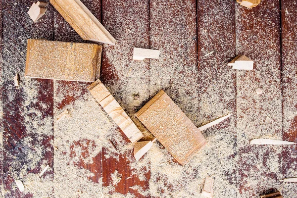 Close up of cutters of wood lying among sawdust — Stock Photo, Image