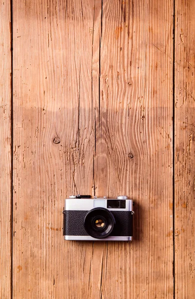 Câmera vintage colocada na mesa. Fundo de madeira. Estúdio — Fotografia de Stock