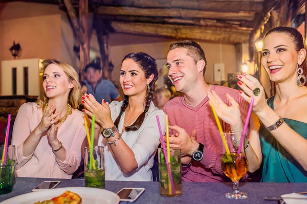 Young beautiful people with cocktails in bar or club — Stock Photo, Image