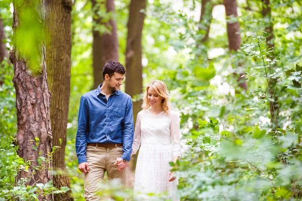 Wedding couple on walk in forest — Stock Photo, Image