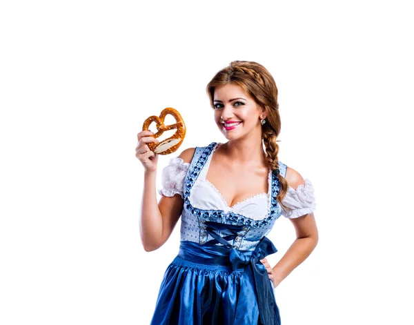 Woman in bavarian dress with pretzel — Stock fotografie