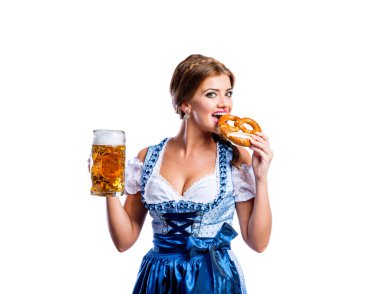 Woman in bavarian dress with pretzel and beer