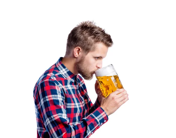 Man in checked shirt drinking beer — Stock Photo, Image