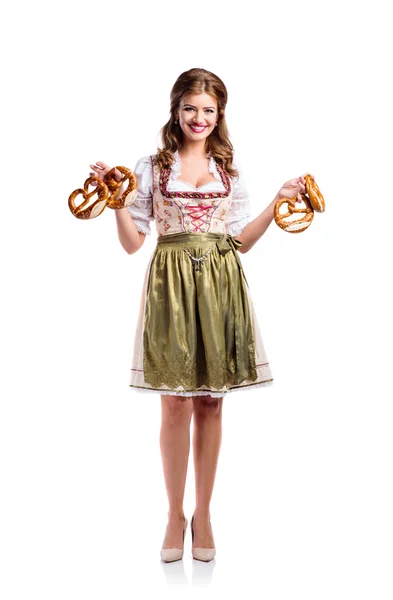 Woman in bavarian dress holding pretzels — Stock fotografie