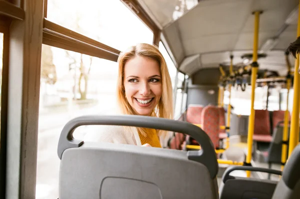 Beautiful young woman traveling by bus, having fun — Stock Photo, Image