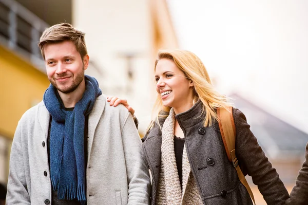 Young woman and man on a walk in town — Stock Photo, Image