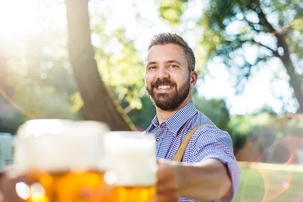 Man in bavarian clothes with beer — Stock Photo, Image