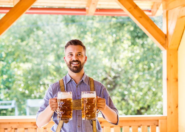 Man in bavarian clothes with beer — Stock Photo, Image